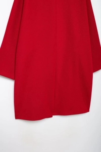 Close-up of red textured wool fabric on a women's long-sleeved mid-length autumn coat