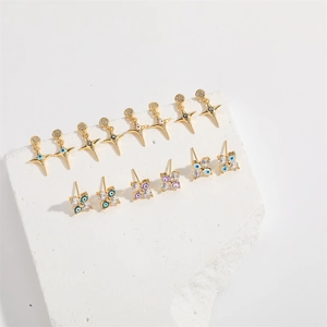 Detailed display of gold star and clover earrings with colorful devil eye gems