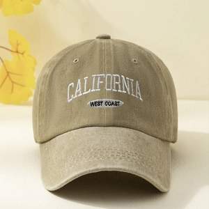 Close-up of embroidered California West Coast text on a washed khaki baseball cap