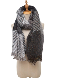 Detailed view of plaid and herringbone wool blend scarf with fringe tassels