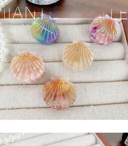 Macro view of assorted shell hair clips with golden lines and pearlescent finish