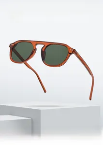 Macro detail of amber tortoiseshell frames with dark lenses on a minimalist stone base