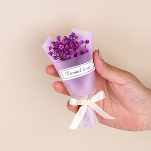 Close-up of mini purple dried gypsophila bouquet with beige ribbon and Eternal love tag
