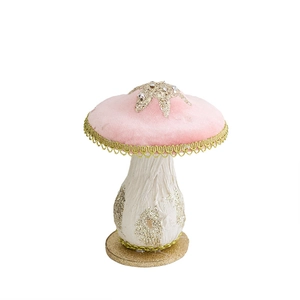 Pink velvet Christmas mushroom decoration with gold star patterns and a glittery base