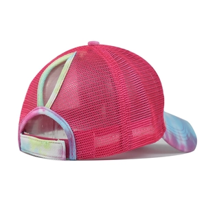 Detail of breathable pink mesh ponycap with colorful tie-dye patterns and high ponytail hole