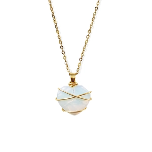 Minimalist gold plated wire wrapped heart shaped crystal necklace on white background