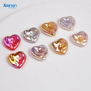 Detail of colorful metallic heart-shaped beads with wrinkled texture and iridescent finish