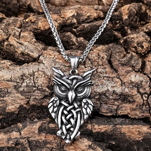 Vintage Viking owl pendant in stainless steel with Celtic knots on rustic bark background