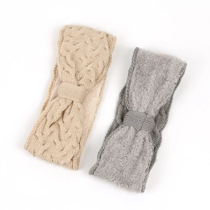 Close-up of beige and grey cable knit headbands with soft fleece lining for winter