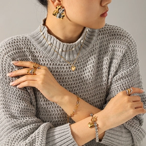 Elegant two-tone heart and flower jewelry set with necklaces and bracelets on model