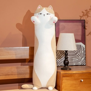 Detailed view of cat plush pillow with pink paw embroidery in a warm home setting