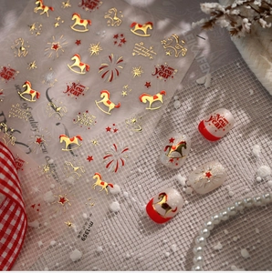 Macro detail of laser gold horse nail stickers with New Year motifs and fireworks