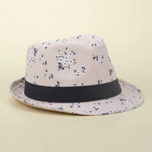Detail of floral straw sun hat showing delicate daisy patterns and black ribbon trim