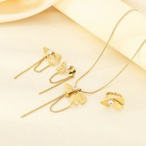 Golden bow jewelry set featuring pearl tassels with necklace, earrings and ring