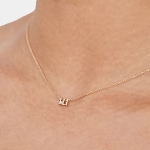 Close-up of gold S925 sterling silver necklace featuring a sparkling 111 angel number pendant