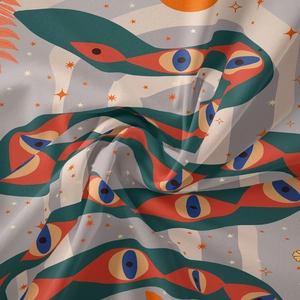 Detailed close-up of Bohemian tapestry fabric with mystical eye and celestial star patterns
