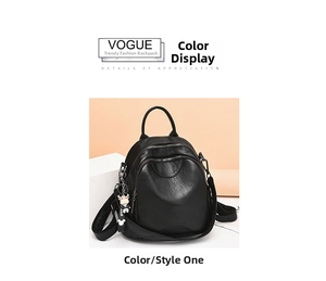 Detail view of black faux leather backpack with cartoon charm and multi-zipper structure