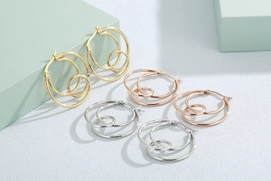 Detail of knot earrings in gold, silver, and rose gold with overlapping round design