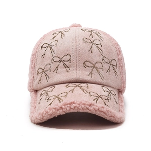 Stylish pink lamb wool baseball cap featuring sparkling rhinestone bow designs for women