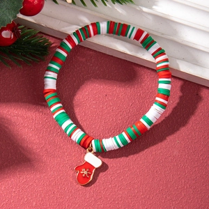 Detail of beaded Christmas bracelet with red enamel glove charm and red white clay beads