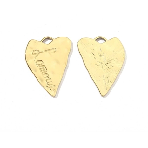 Detailed view of golden heart-shaped pendants with J'amour engraving and radial texture