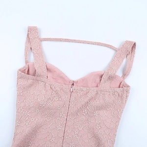 Detail view of pink lace dress showing the intricate floral texture and back zipper
