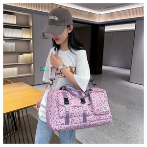 Detail view of pink leopard print fitness bag showing crossbody strap and large capacity