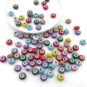 Macro view of assorted colorful large-hole beads with turquoise patterns and metal inserts