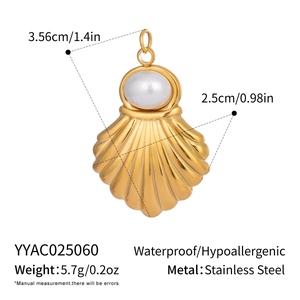 Macro detail of a 18K gold-plated stainless steel shell pendant with a white pearl inlay