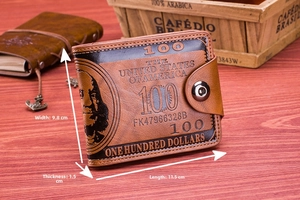 Close-up of vintage brown leather men's bifold wallet with dollar bill print and metal buckle