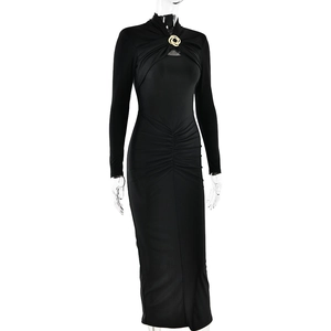 Detail of elegant black slim fit maxi dress featuring a gold metallic knot brooch detail