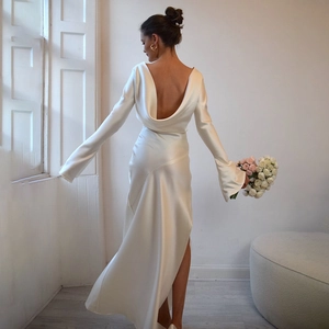 Detail of elegant backless satin dress with long sleeves and graceful draped neckline