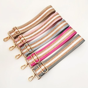 Detail of adjustable 5cm striped shoulder straps with gold metallic thread and hardware