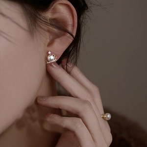 Elegant crown pearl stud earrings with zircon inlay on model with matching ring