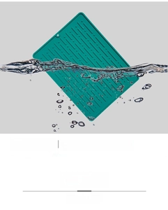 Detail of green silicone draining mat with hanging hole and ribbed anti-slip surface