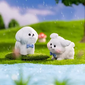 Miniature white cartoon dog figurines with blue bows on a mossy landscape background