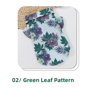 Detail of Hawaiian pet shirt featuring tropical hibiscus and palm leaf print