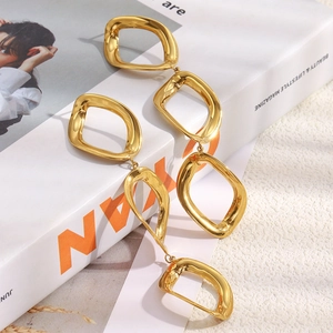 Close-up of triple interlocking geometric rhombic earrings in 18K gold-plated stainless steel