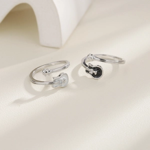 Detail of silver guitar rings with black and white enamel finish and small rhinestones