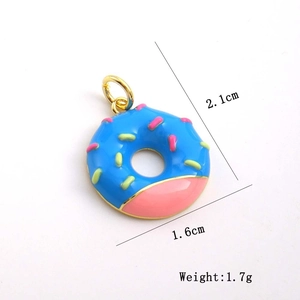 Macro view of a 2.1cm blue donut pendant with pink enamel detail and gold bail