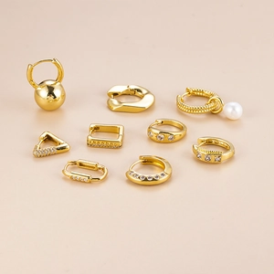 Golden geometric earring set featuring pearl and zircon charms on minimalist backgrounds