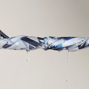 Detail of moisture-wicking fabric with ink pattern showing quick-dry water drainage