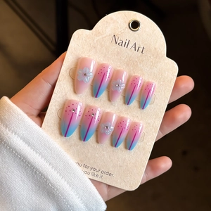 3D floral press-on nails with blue and pink gradient and almond shape design