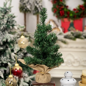 Detailed close-up of a 30cm mini pine Christmas tree with a rustic burlap-wrapped base
