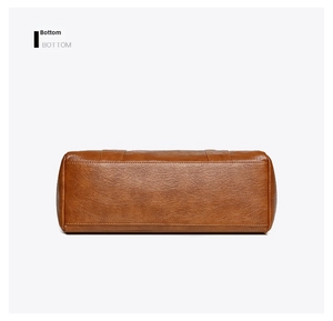 Detailed bottom view showing the refined stitching and lychee grain brown leather texture