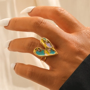 Artistic gold plated stainless steel heart ring with colorful enamel inlay on model hand