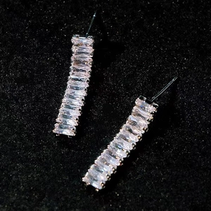 Elegant silver earrings with rectangular cubic zirconia stones on black background