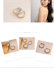 Detail of two-tone hammered texture hoop earrings in gold and silver finish on a model