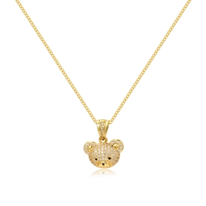 Close-up of golden teddy bear pendant with micro-pave crystals on a minimalist chain