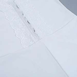 Close-up of delicate lace trim and stitching on white sporty yoga jumpsuit detail